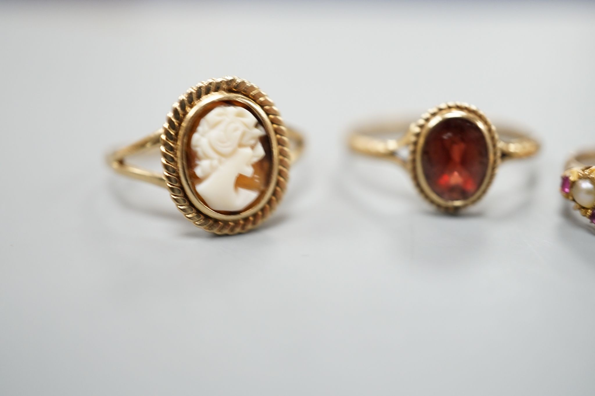 A late Victorian 15ct gold, seed pearl and amethyst cluster set ring, size L, gross 2.1 grams and two later 9ct gold rings including cameo shell, gross 3.2 grams.